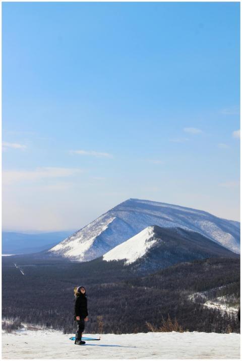 Woman hiking in a snowy mountain landscape under a