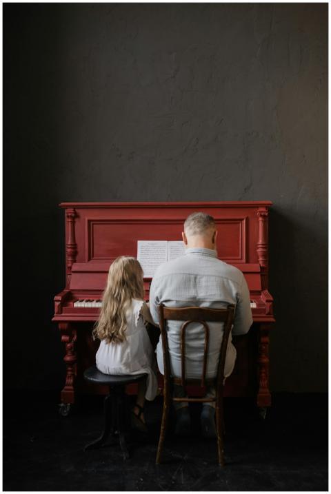 Elderly man and young girl bonding over music whil