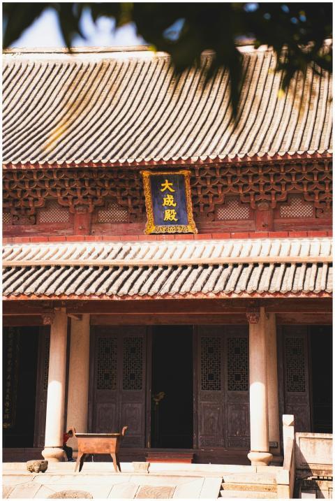 Sunlit view of a traditional Asian temple with orn