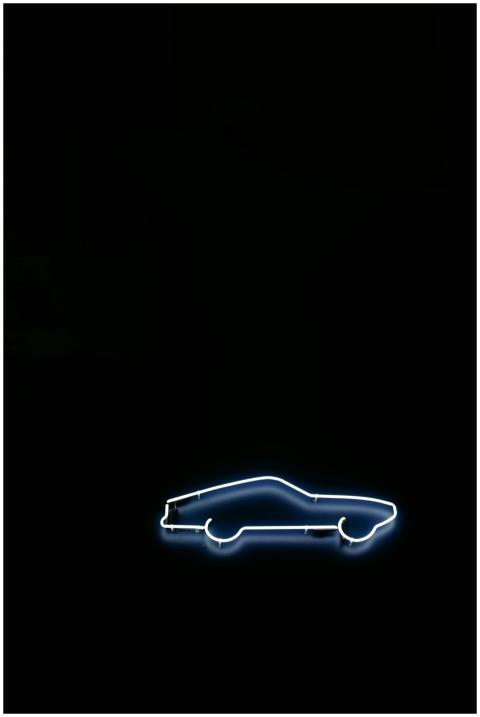 Minimalist neon sign of a car on a black backgroun