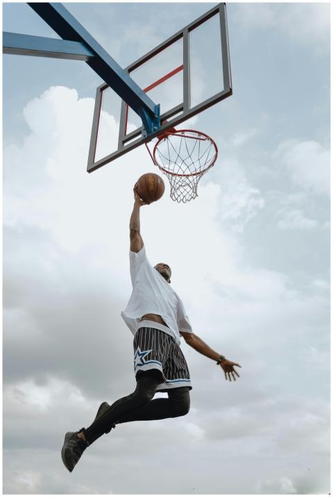 A basketball player in midair performing an impres