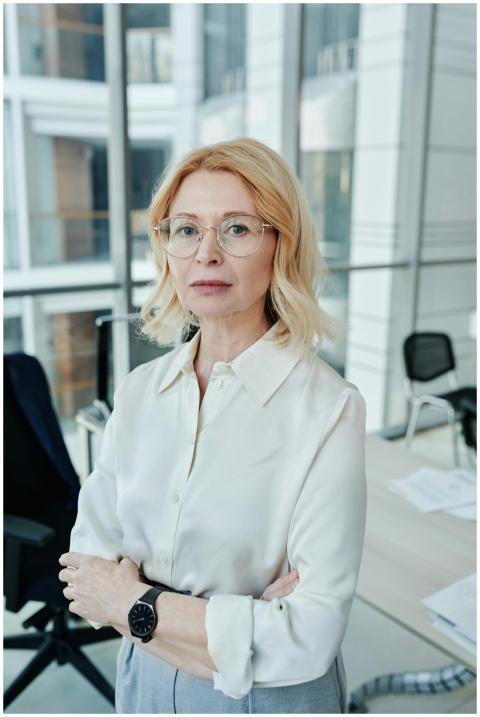 Professional woman with glasses standing confident