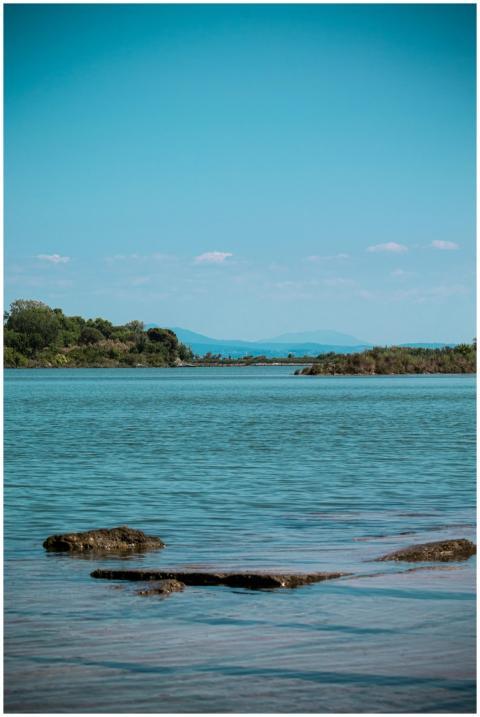 Peaceful lake scene with clear blue sky and distan