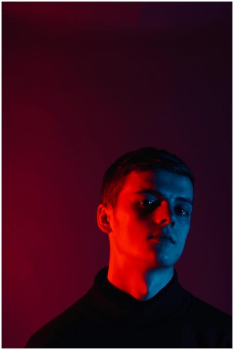 Striking studio portrait of a young man with red a