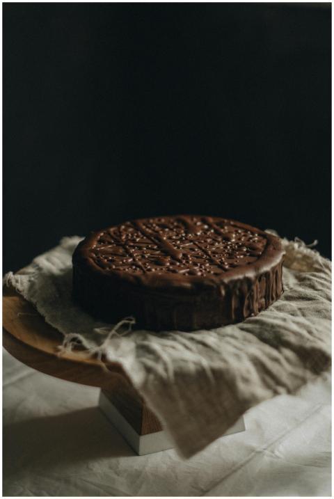 Delicious chocolate cake placed on rustic linen, i