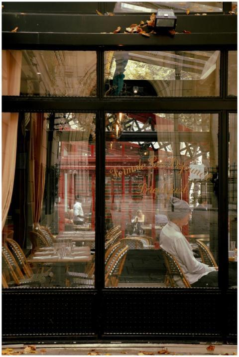 Chic Paris café interior seen through a reflective