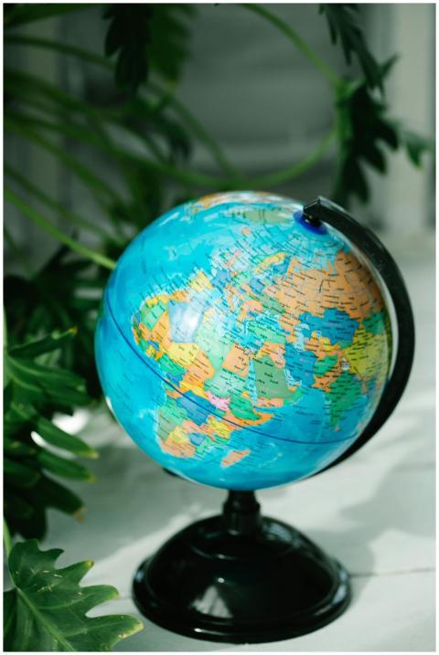 Vibrant globe on a stand surrounded by lush green
