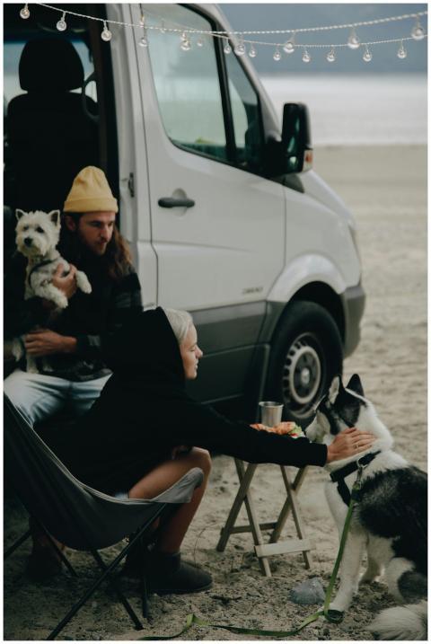 A couple enjoys a beachside camping experience wit