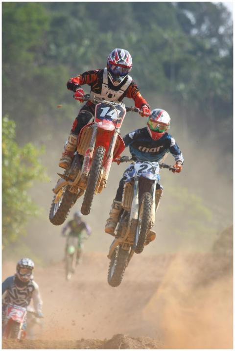 Exciting motocross race with bikers performing jum