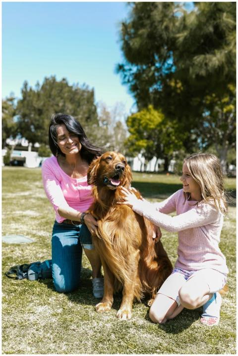 A cheerful family moment outdoors with a golden re