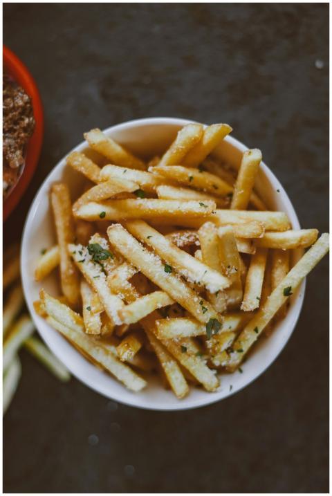 A bowl of crispy, delicious french fries garnished