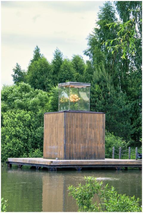 A serene wooden structure by a lake surrounded by