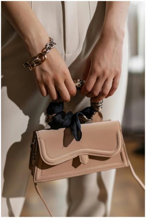 Close-up of hands holding a fashionable beige hand