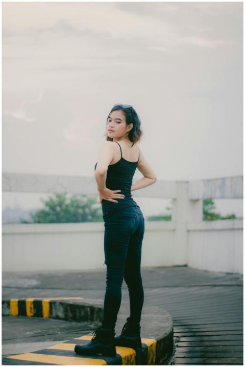 Fashionable woman poses confidently outdoors in a