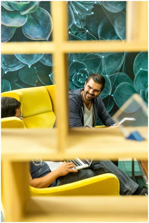 Two professionals in a modern office setting, disc