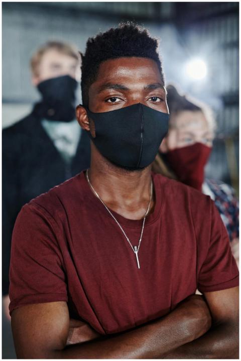 Group of diverse individuals wearing masks and pra