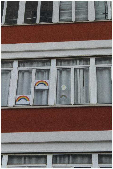 Vibrant rainbow drawings decorate apartment buildi