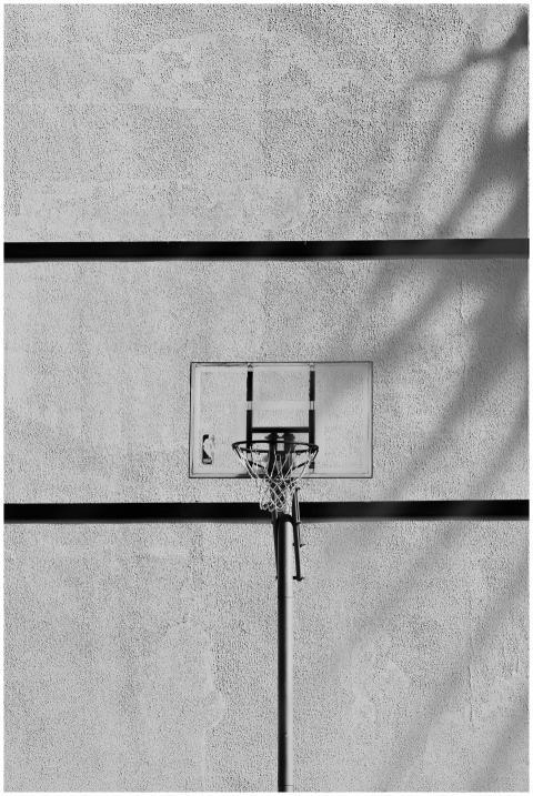 Black and white image of a basketball hoop on an o