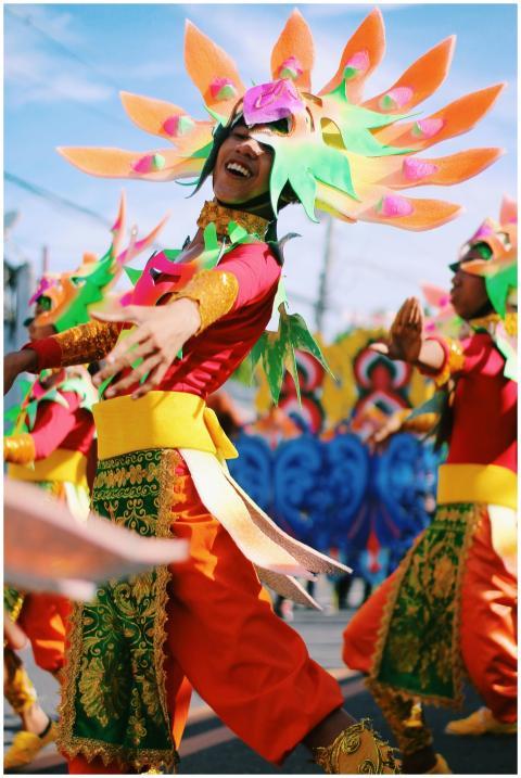 Colorful dancers in traditional attire celebrate t