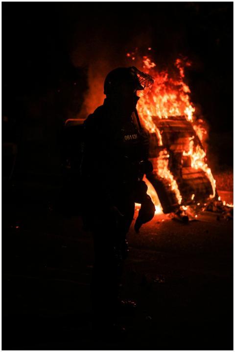 A tense night scene in Bogotá with a silhouette of