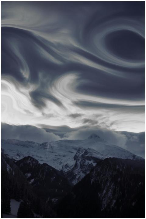 Stunning view of swirling clouds above snow-covere