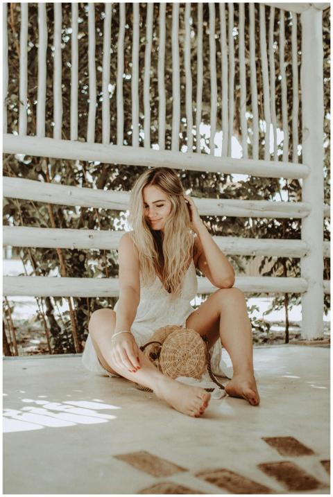 A serene outdoor photoshoot featuring a smiling bl