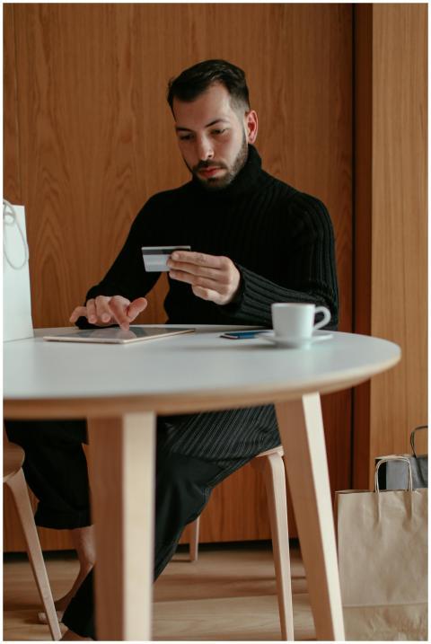 Young man using credit card and tablet for online