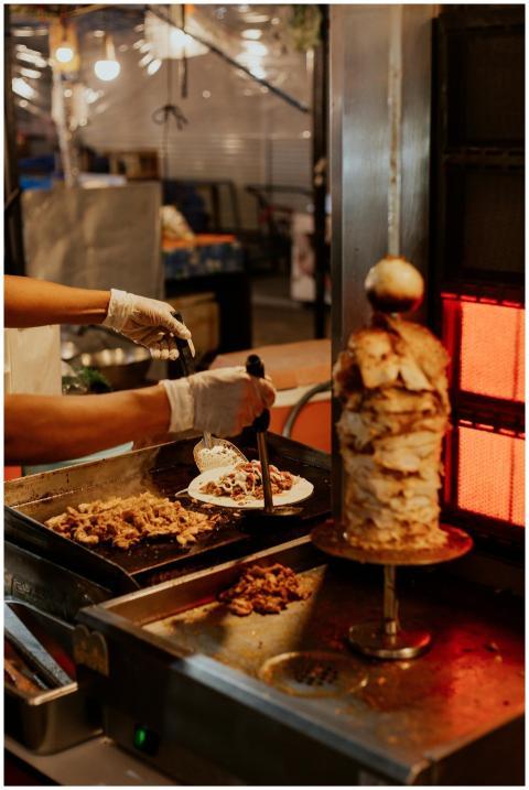 Chef prepares doner kebab with fresh ingredients a