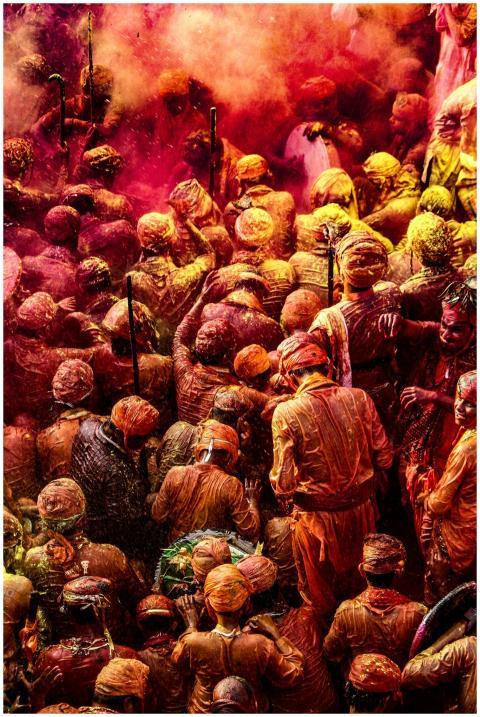 Colorful crowd celebrating Holi with vibrant powde