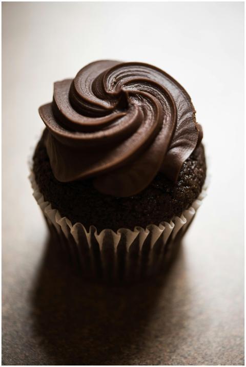 Delicious chocolate cupcake topped with rich, crea