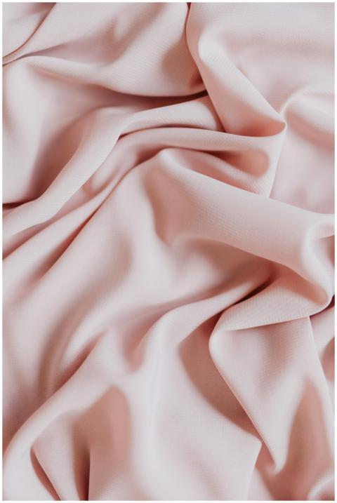 Close-up of an elegant pink fabric with smooth fol