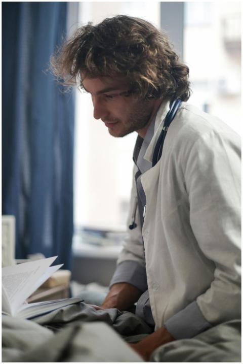 A medical professional in a white coat and stethos