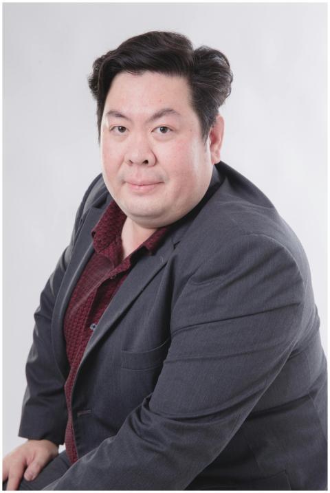 Portrait of an adult man in a suit with a neutral