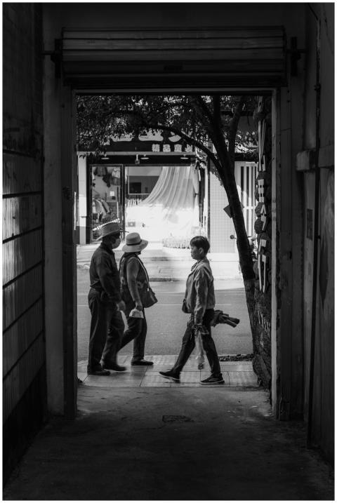 Monochrome image of pedestrians walking through a
