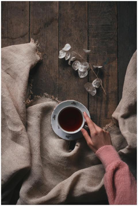 From above of crop anonymous female taking cup of