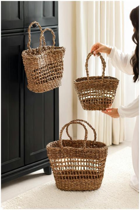 Stylish woven straw baskets being arranged by a wo