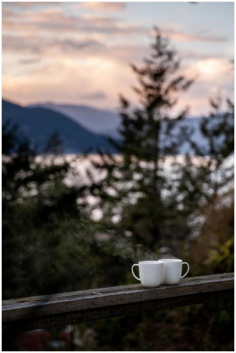 Serene landscape view with two coffee mugs on a wo