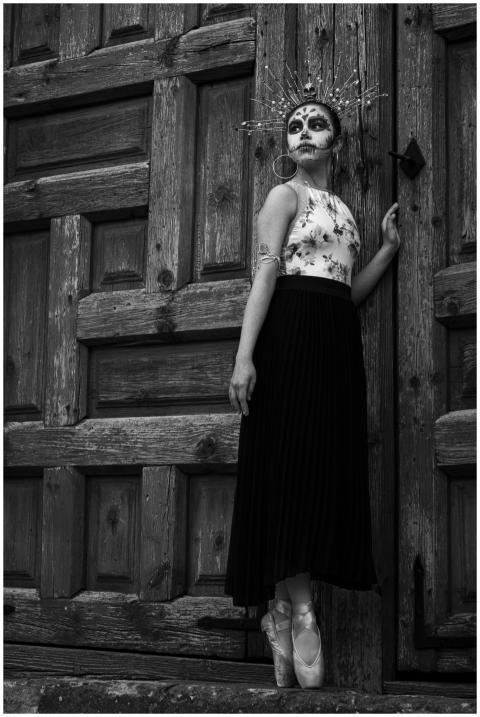 A graceful woman poses in traditional Catrina atti