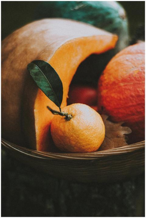 Colorful tangerine with leaf in wicker basket with