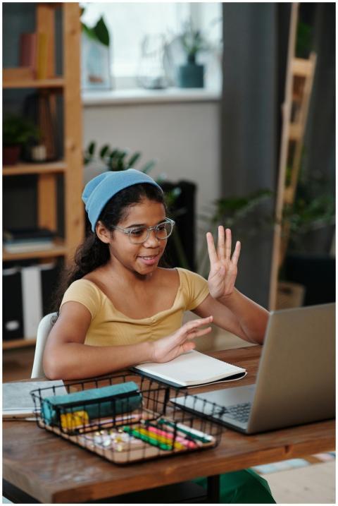 A girl with glasses and a headband participating i