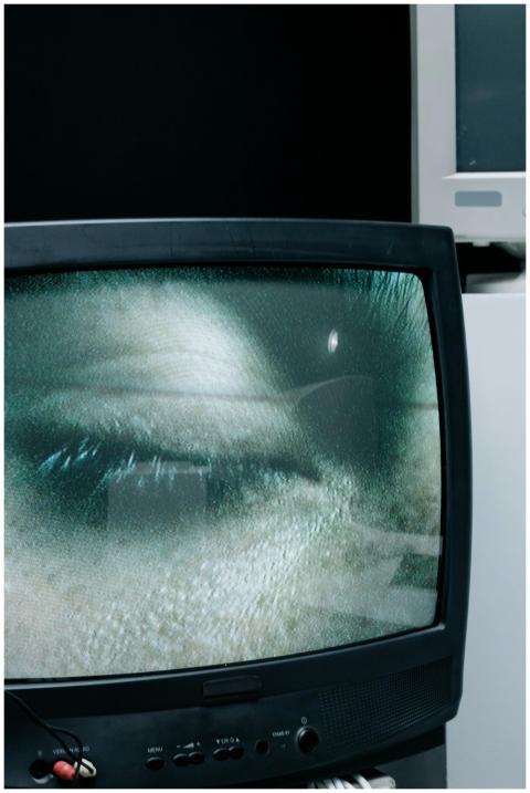 A close-up of a closed eye displayed on a vintage