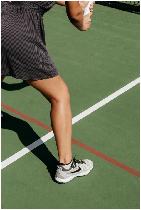 Close-up of a woman on an outdoor tennis court pre