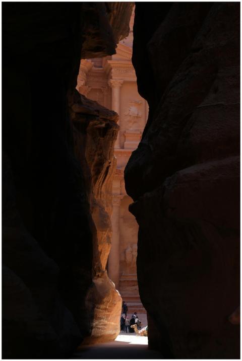 Captivating view through the dark Siq canyon to th