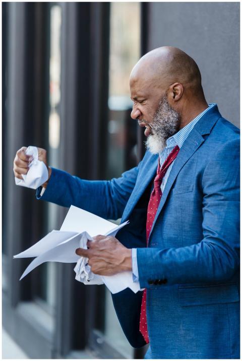 Side view of furious African American male entrepr