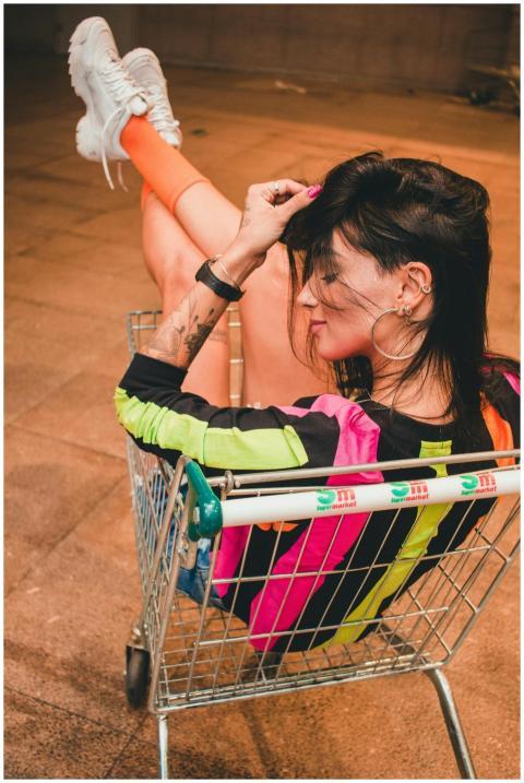 Fashionable woman sitting casually in a shopping c