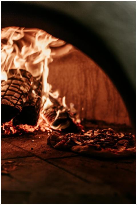 A delicious Italian pizza cooking in a traditional