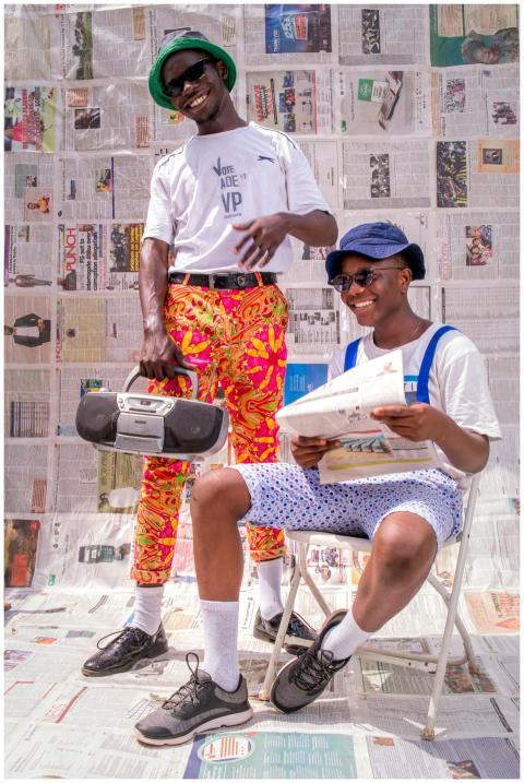 Two stylish men enjoy music and reading against a