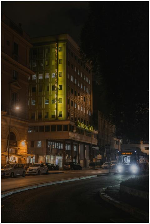 A nighttime urban scene featuring a brightly lit b