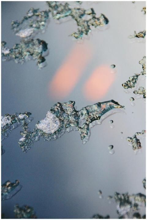 Intricate macro shot of melting ice with water dro