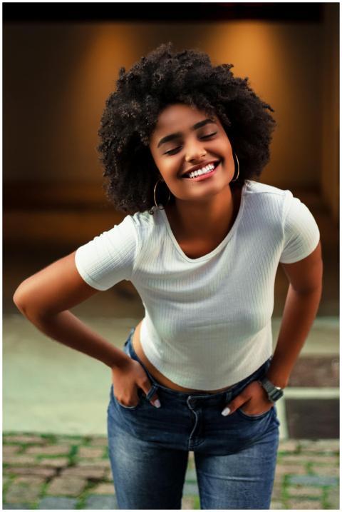 African American woman with afro hair smiling in c